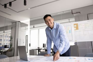 Happy Asian business leader man posing at large...