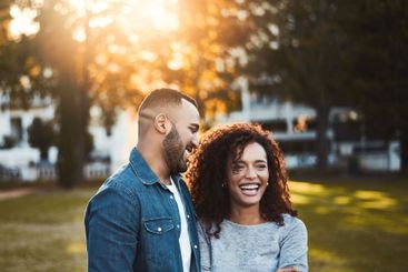 Happy, morning and couple in park laugh together for...