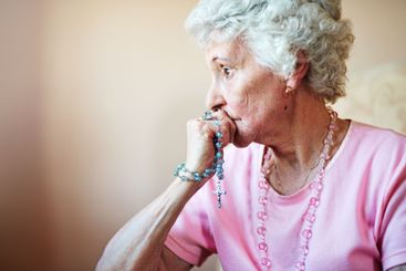 Old woman, Christian and rosary beads in home, spiritual...