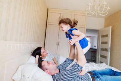 Parents having fun with their cute little daughter