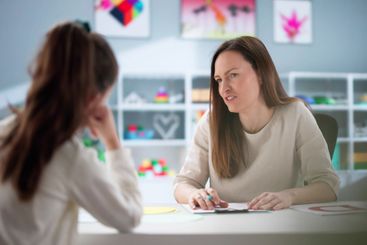 Child psychiatrist providing therapy