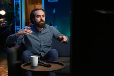 Excited fan watching live sports event on TV, rooting...