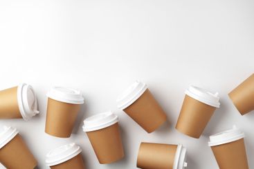 A variety of disposable coffee cups arranged...