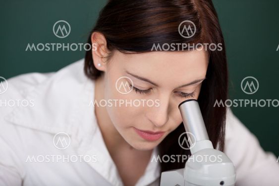 Young woman using a microscope