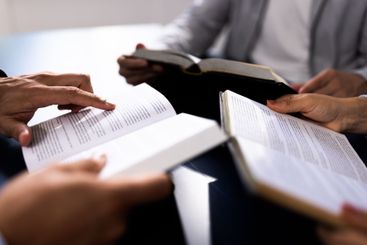 Christian Preacher Reading Holy Bible With Friends in...