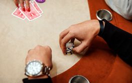 Player with chips at a table in a casino.