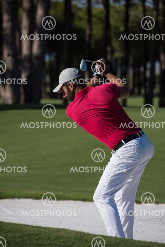 golfer hitting a sand bunker shot