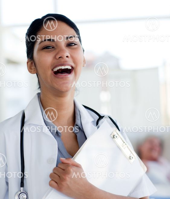Laughing doctor holding a medical clipboard