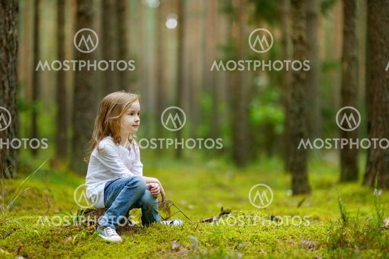 Adorable little girl hiking in the forest