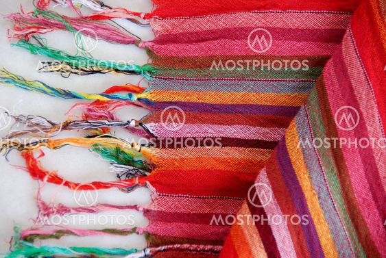 Colored Mexican tissue lined with multicolored threads.