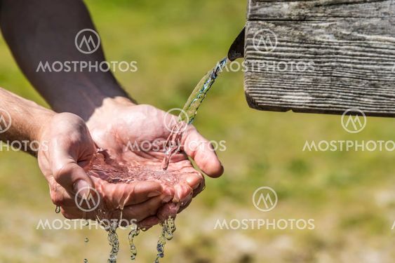 Thirsty Hands taking water from well