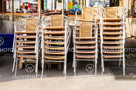 Groups of chairs stacked and chained together outdoors