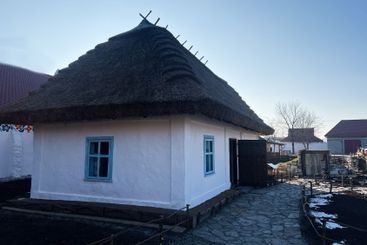 Traditional white house with thatched roof in a rural...