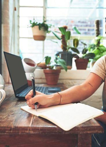 Laptop, writing and person with notes for creative...