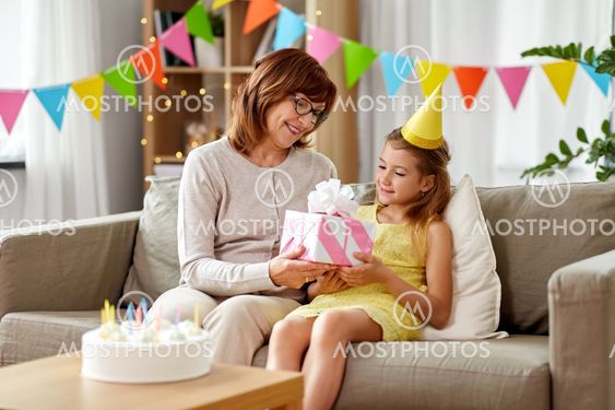 grandmother giving granddaughter birthday gift