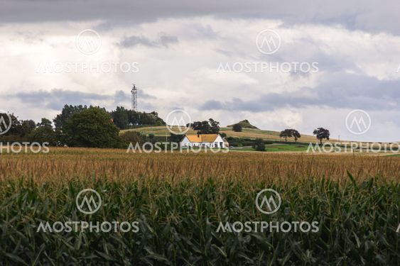 A modern home is embedded in the agricultural fields in...