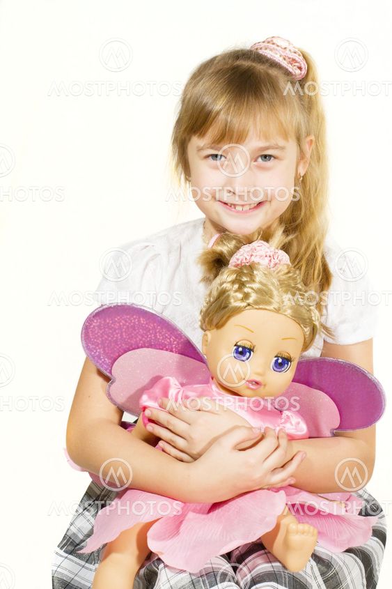 Beautiful little girl playing with a doll.