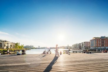 People on boardwalk at sunset in Stockholm, Sweden