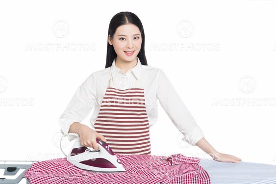 young housewife ironing