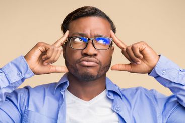 Thoughtful Black Man Concentrating Hard Standing On...