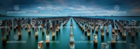 Old Pier Stumps in the blue sea water of Port Melbourne, Australia