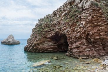 Beautiful rocks and bright turquoise water among layered...