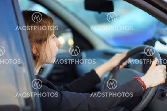 Young woman sitting in a car