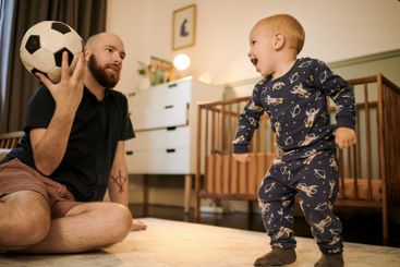 Family, father and son with a ball, playing and bonding...