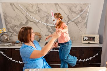 Easter Spring festival. Caucasian Mother plays together...