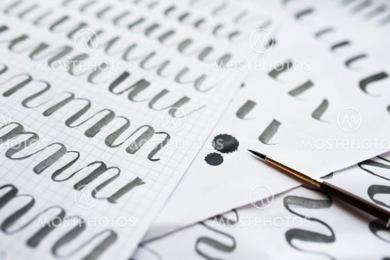 vintage pen on a handwritten paper concept calligraphy...