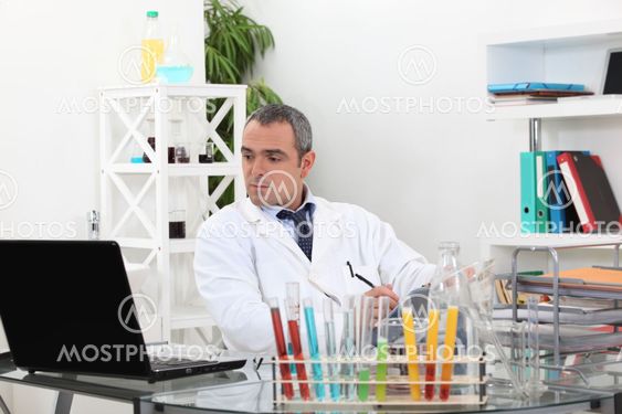 Man looking up results on a computer