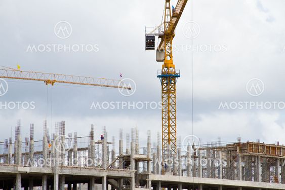 Tower crane and building structure with blue sky, Thailand.