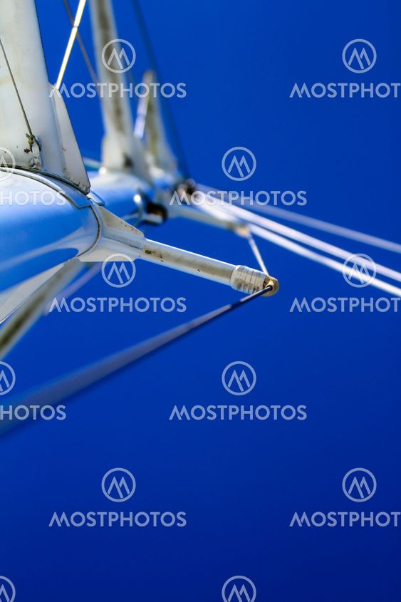 Looking at boat mast with rigging and blue sky