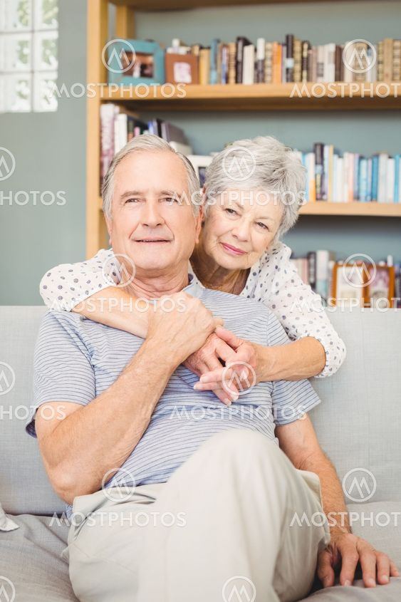 Happy romantic senior couple in living room
