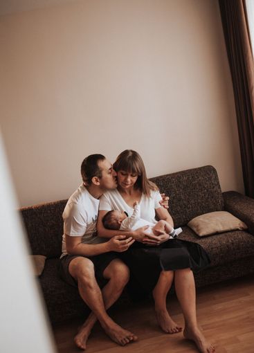 newborn baby in the arms of parents