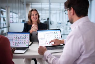 Manager schedules team events using online calendar...