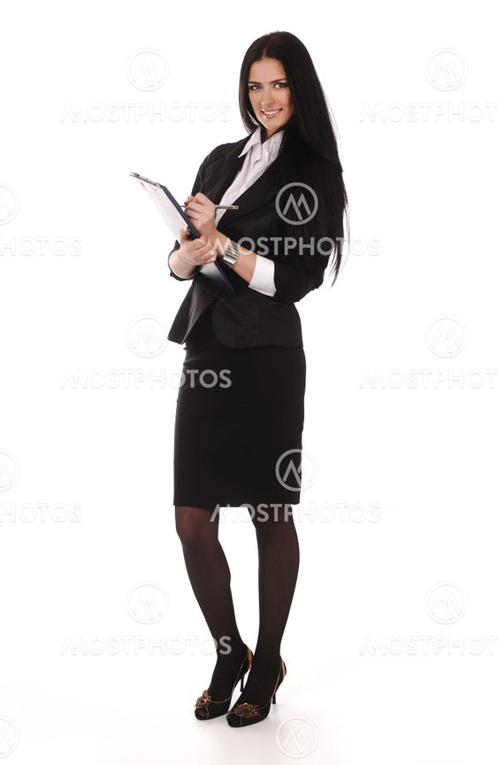 Confident young business woman standing with folder in...