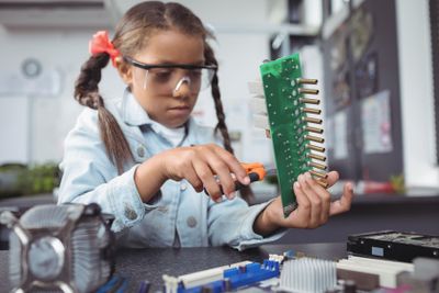 Concentrated elementary girl assembling circuit board