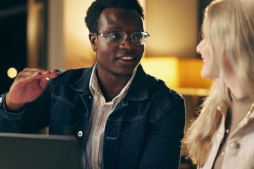 Laptop, teamwork and business people together at night...