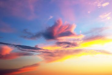a vibrant sky after sunset, with deep orange and pink...