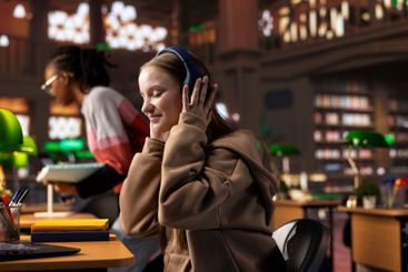 College student listening to ambient study music on...