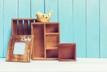 Cozy pastel wooden home decor objects on blue background