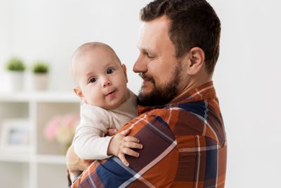 happy father with little baby boy at home