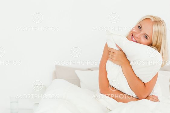 Cute woman holding a pillow