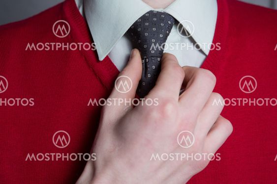 Man wearing white shirt, red sweater and necktie