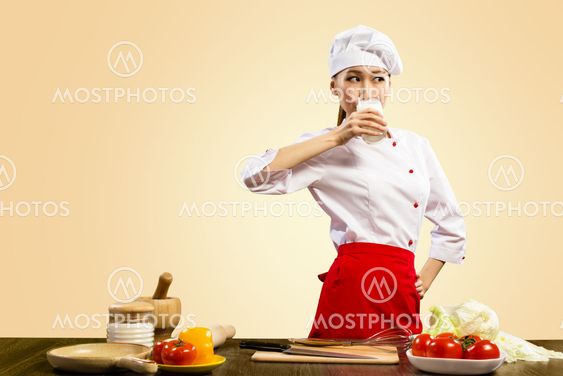 Asian female cook drinking milk