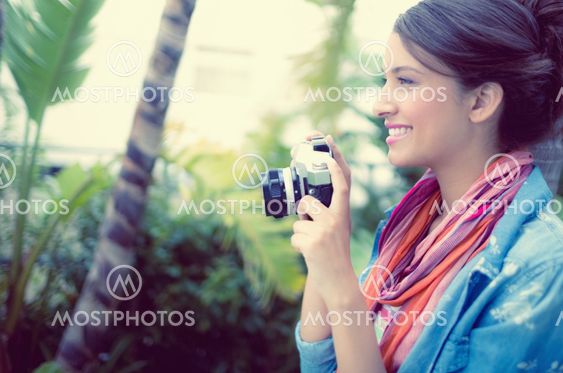 Smiling brunette taking a photo