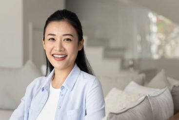 Happy beautiful young Vietnamese woman posing for portrait
