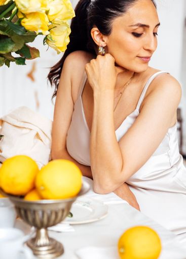 A young woman is sitting in profile and waiting for...