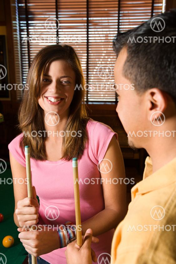 Couple playing pool.